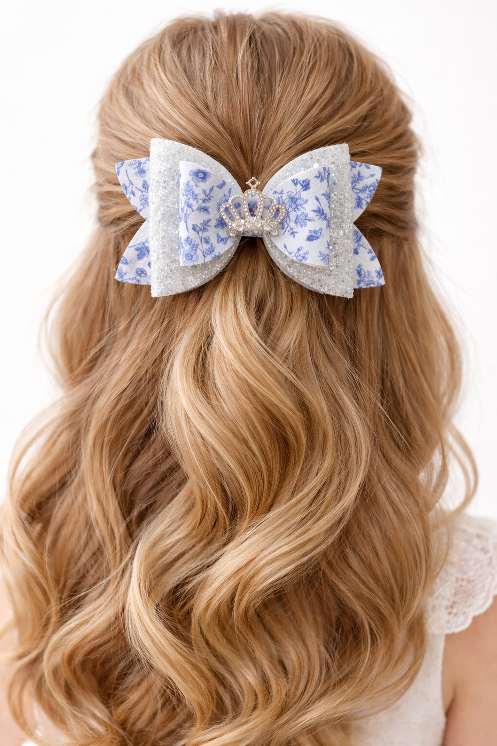 Blonde hair with a decorative blue and white bow on a white background